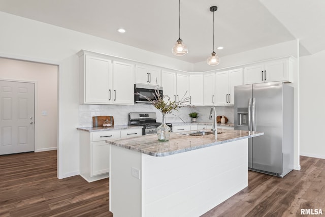 kitchen with decorative backsplash, appliances with stainless steel finishes, dark hardwood / wood-style floors, and white cabinetry