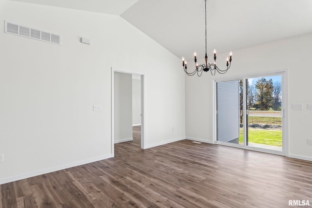 empty room featuring a chandelier, hardwood / wood-style floors, and high vaulted ceiling