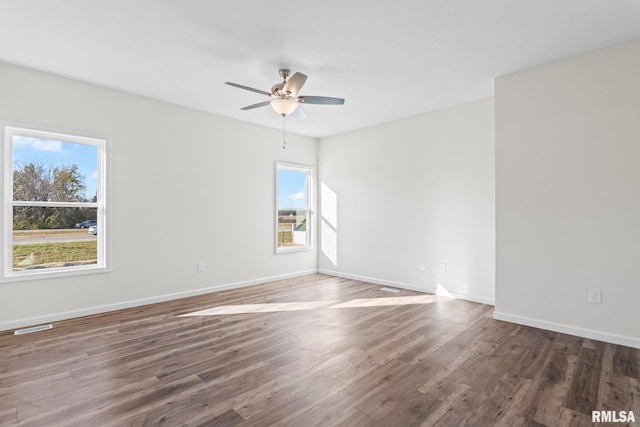 empty room with ceiling fan and dark wood-type flooring