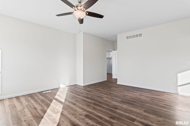 empty room featuring dark hardwood / wood-style flooring and ceiling fan