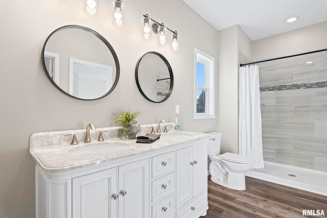 bathroom featuring vanity, toilet, hardwood / wood-style flooring, and a shower with shower curtain