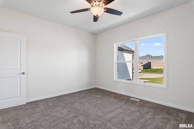 carpeted empty room featuring ceiling fan