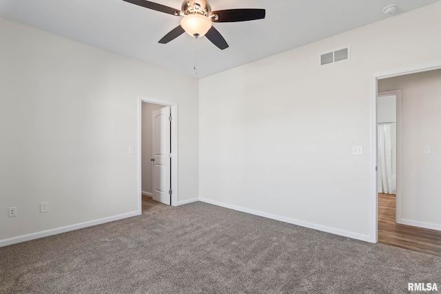 carpeted spare room featuring ceiling fan