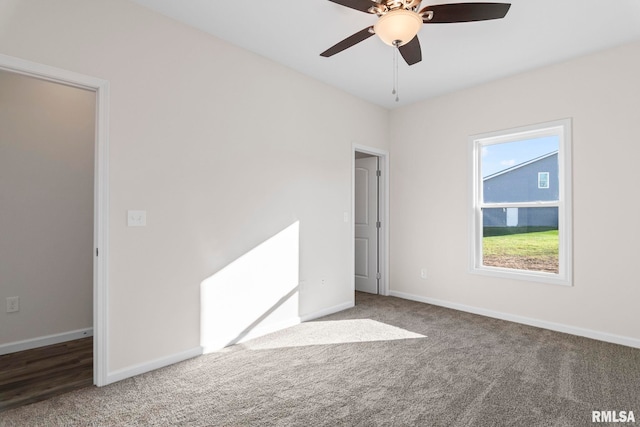 carpeted spare room featuring ceiling fan