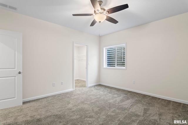 carpeted empty room with ceiling fan