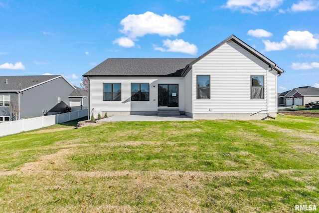 rear view of property with a yard and a patio