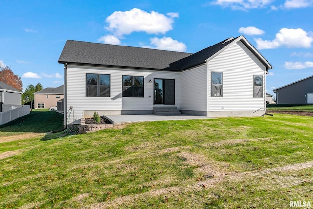 rear view of property featuring a yard and a patio