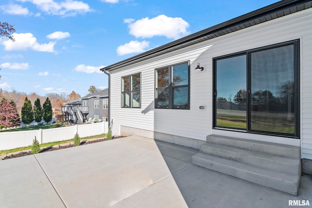 view of side of home with a patio area