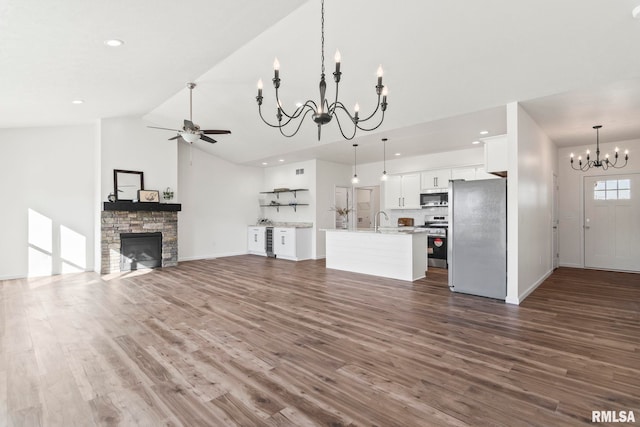 unfurnished living room featuring a fireplace, dark hardwood / wood-style flooring, high vaulted ceiling, and sink