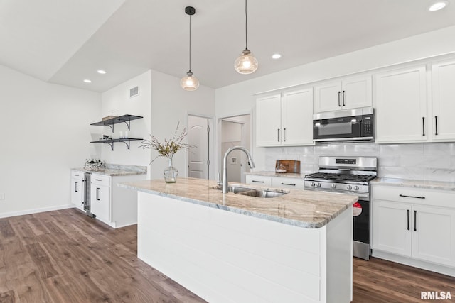 kitchen with a center island with sink, white cabinets, appliances with stainless steel finishes, and sink