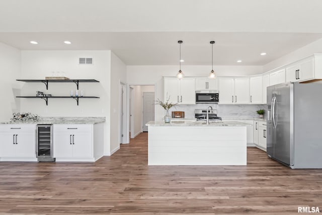 kitchen featuring dark hardwood / wood-style flooring, stainless steel appliances, pendant lighting, white cabinets, and wine cooler