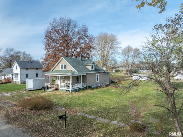 rear view of property with a lawn and a porch