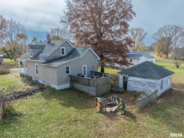 rear view of house featuring a yard and a deck