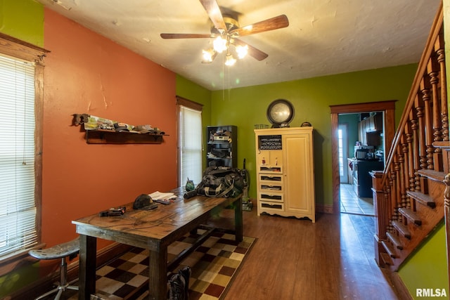 dining space with ceiling fan and dark wood-type flooring