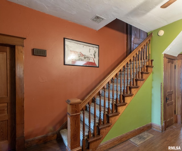 stairway featuring hardwood / wood-style floors