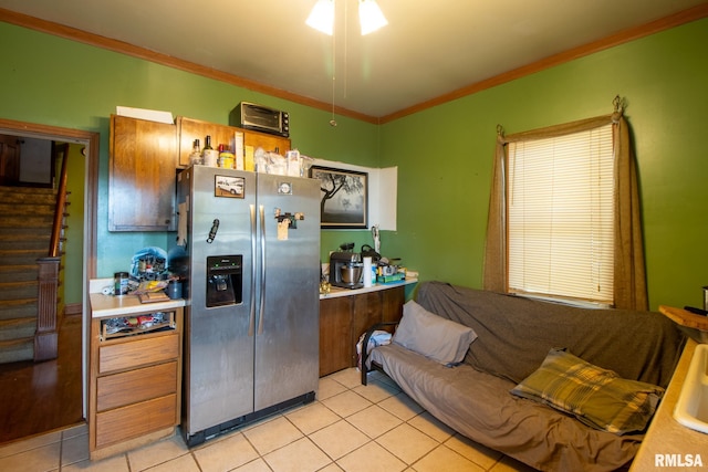 kitchen with stainless steel fridge with ice dispenser, ceiling fan, ornamental molding, and light tile patterned flooring