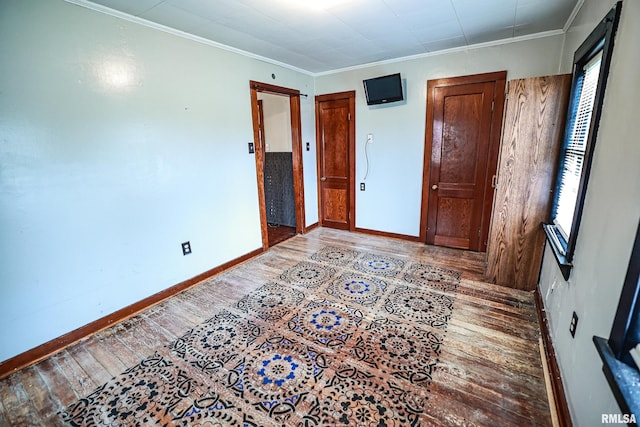 bedroom with hardwood / wood-style floors and ornamental molding