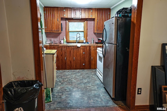 kitchen with electric range, stainless steel fridge, ornamental molding, and sink