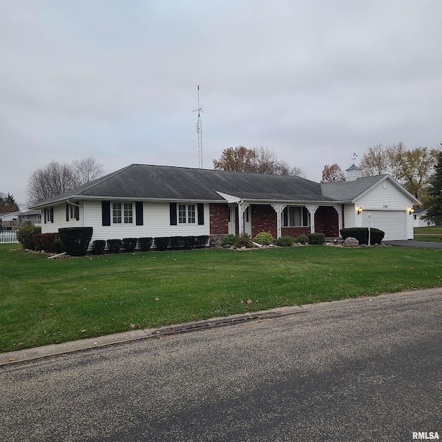 ranch-style house with a garage and a front lawn