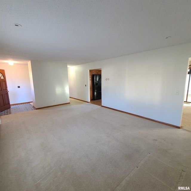 unfurnished room featuring light carpet