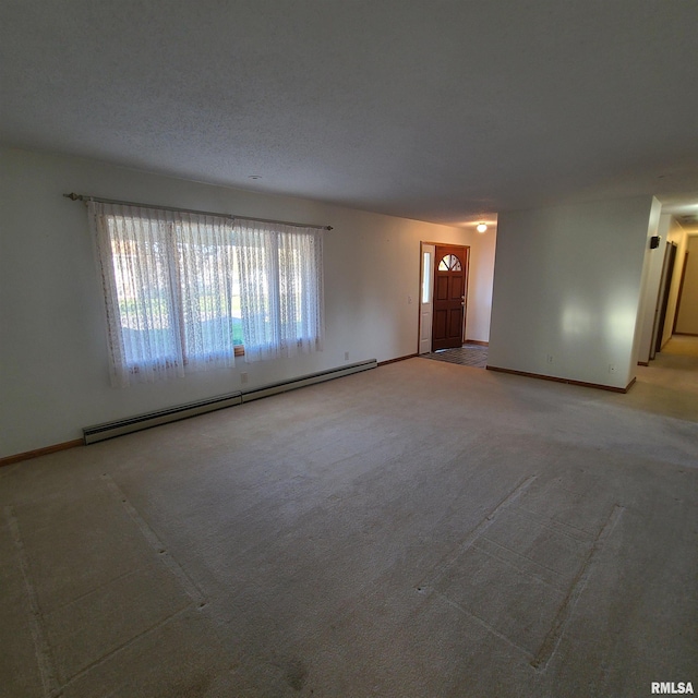 empty room with carpet, a baseboard radiator, and a textured ceiling