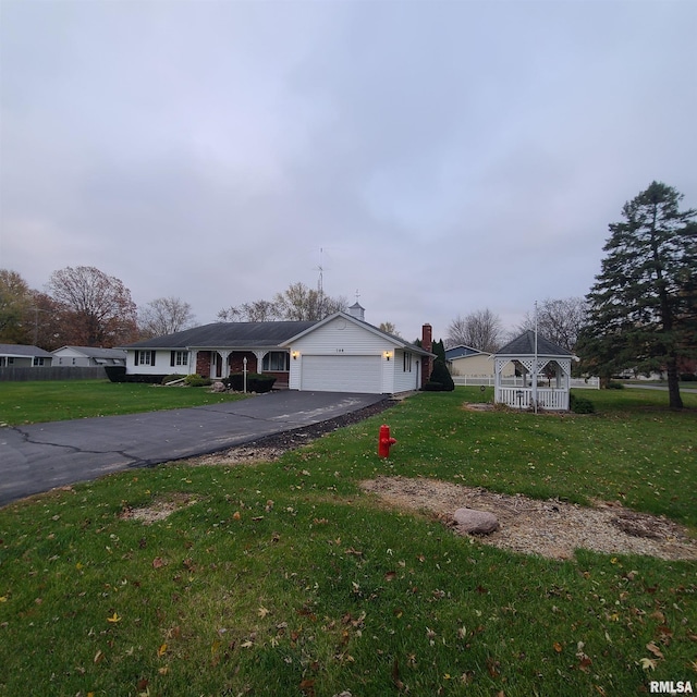 single story home featuring a front yard and a garage