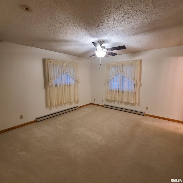 spare room featuring carpet flooring, a textured ceiling, and baseboard heating