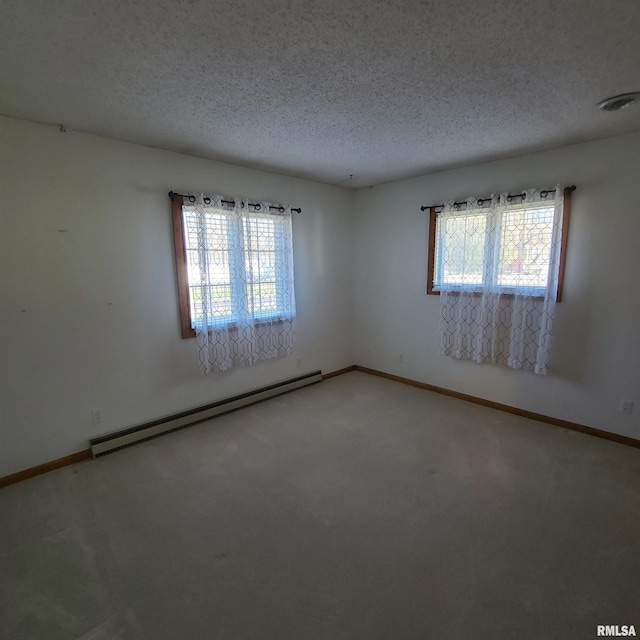 carpeted spare room featuring a textured ceiling and a baseboard radiator