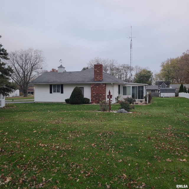 back of house featuring a sunroom and a yard