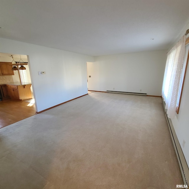 spare room featuring light hardwood / wood-style flooring and baseboard heating