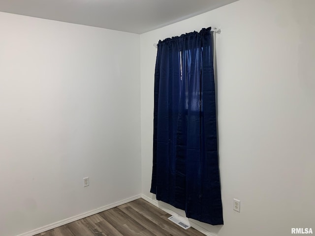 empty room with dark wood-type flooring