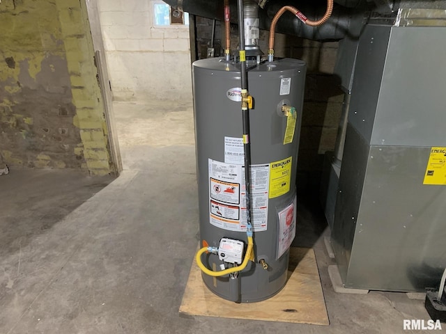 utility room featuring heating unit and water heater