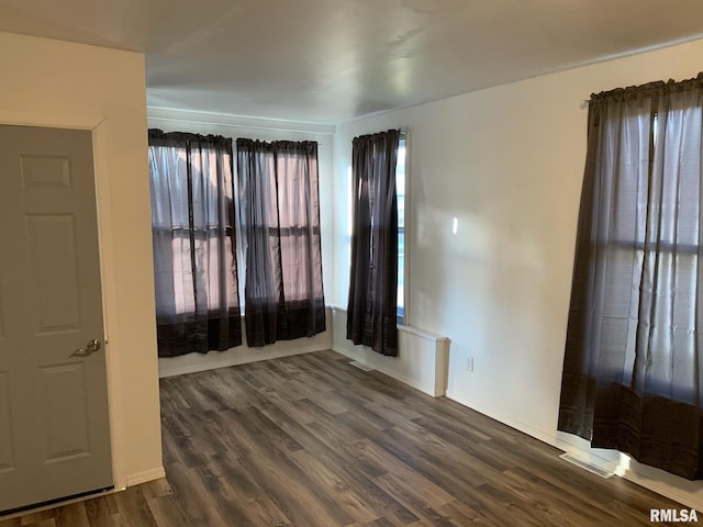 empty room featuring dark hardwood / wood-style floors