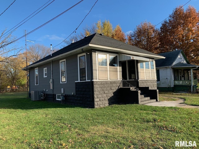 view of side of home featuring a yard and cooling unit