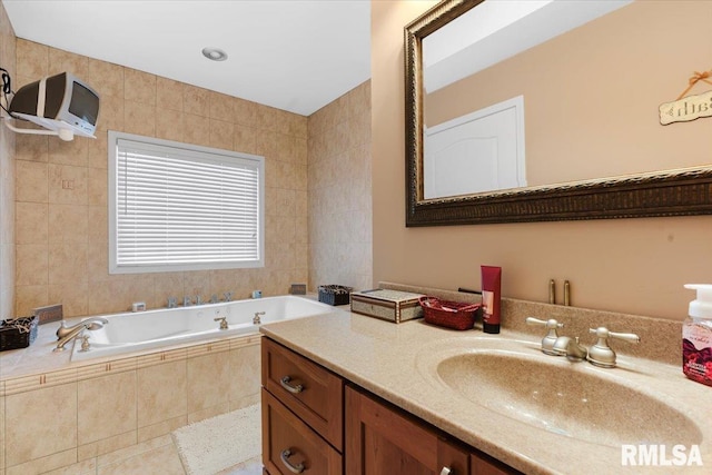 bathroom featuring tile patterned flooring, vanity, a relaxing tiled tub, and tile walls