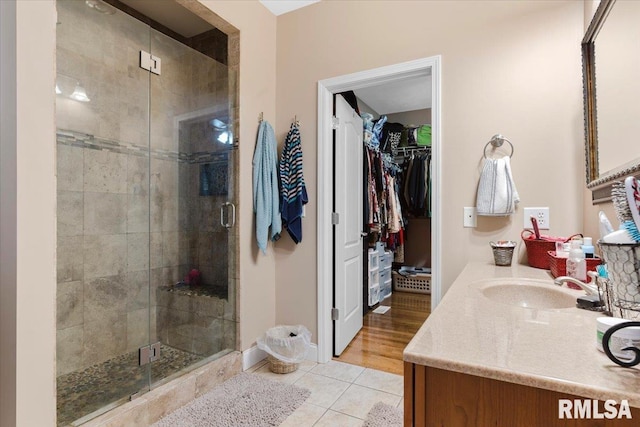 bathroom with vanity, wood-type flooring, and walk in shower