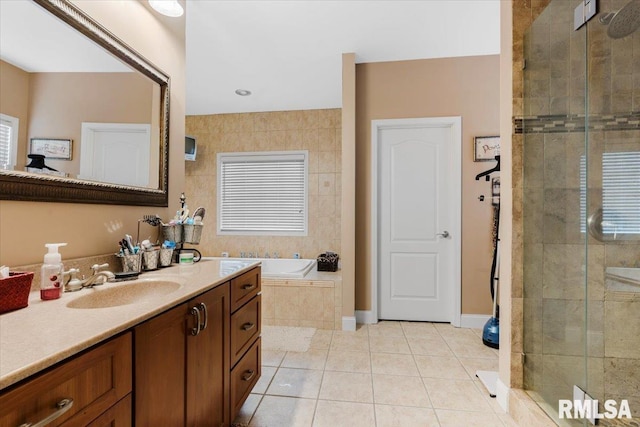 bathroom with tile patterned floors, vanity, and independent shower and bath