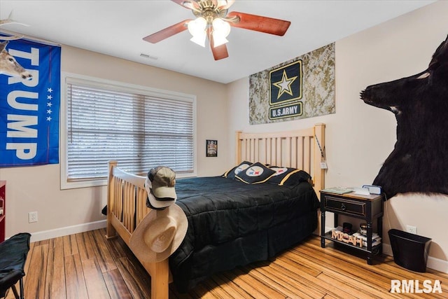 bedroom with ceiling fan and hardwood / wood-style flooring