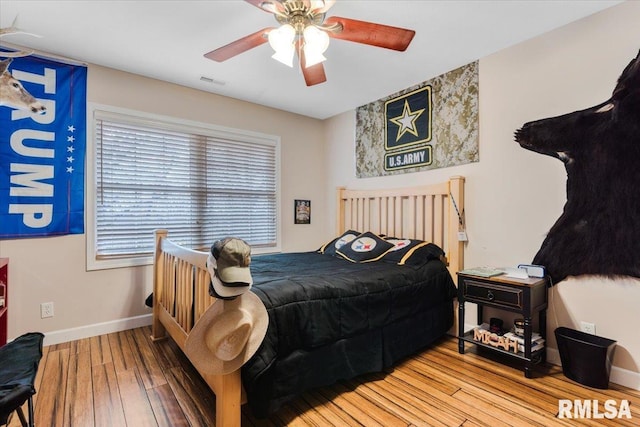 13599 Woodland Dr, Athens, IL 62613 - bedroom with wood-type flooring, baseboards, and a ceiling fan
