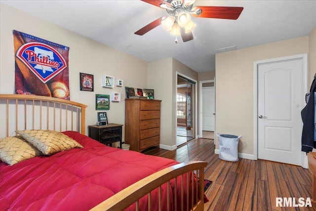 bedroom with ceiling fan and dark wood-type flooring