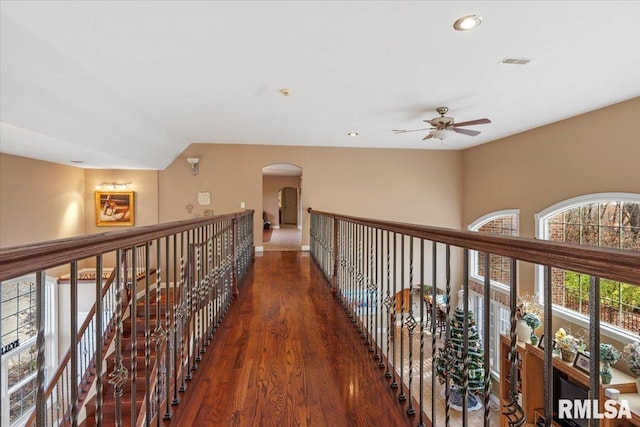 hall featuring dark hardwood / wood-style flooring and vaulted ceiling