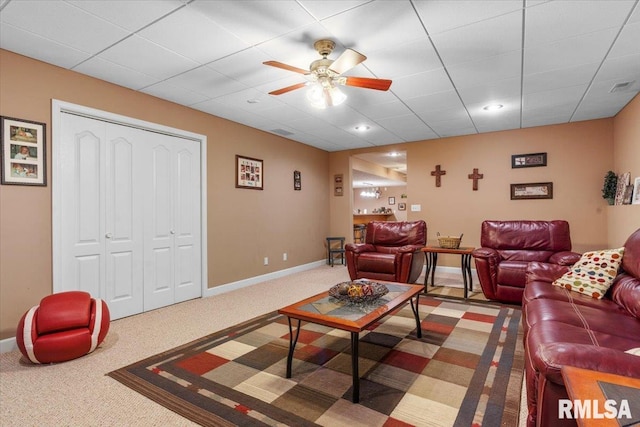 living room with ceiling fan and carpet floors