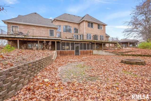 back of property with a sunroom