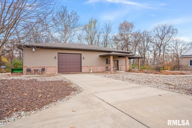 13599 Woodland Dr, Athens, IL 62613 - view of front of house with brick siding, concrete driveway, an attached garage, and a porch