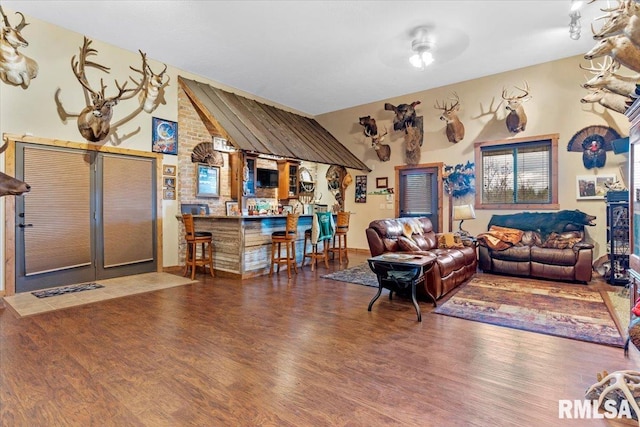 living room with wood-type flooring and lofted ceiling