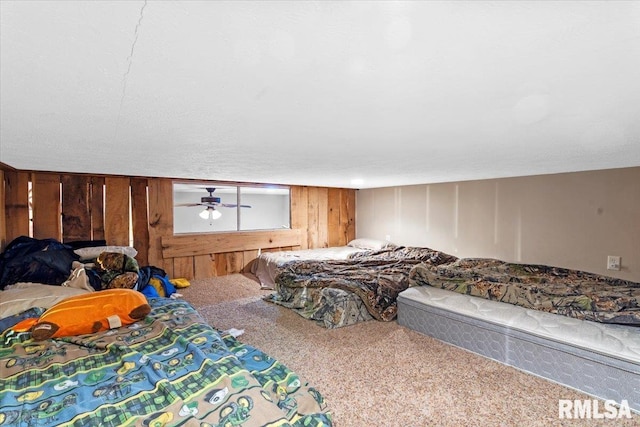 bedroom with carpet flooring and wooden walls