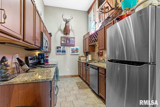 13599 Woodland Dr, Athens, IL 62613 - kitchen with appliances with stainless steel finishes, light stone countertops, baseboards, a sink, and brown cabinets