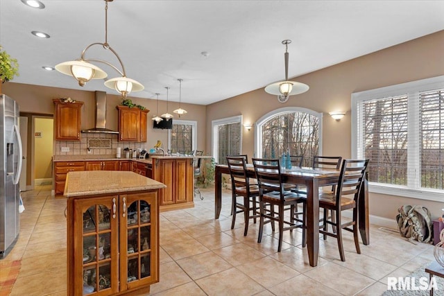 dining space with a healthy amount of sunlight and light tile patterned floors