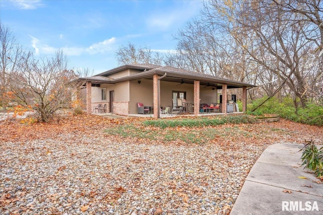 13599 Woodland Dr, Athens, IL 62613 - back of house with ceiling fan, brick siding, and a patio area