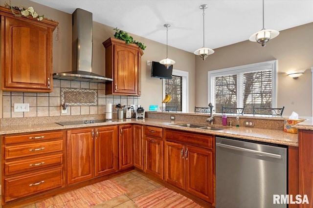 kitchen featuring dishwasher, wall chimney exhaust hood, decorative light fixtures, and sink